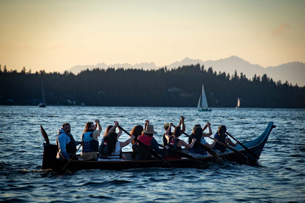 Squaxin Island Tribal members in canoes on the puget sound