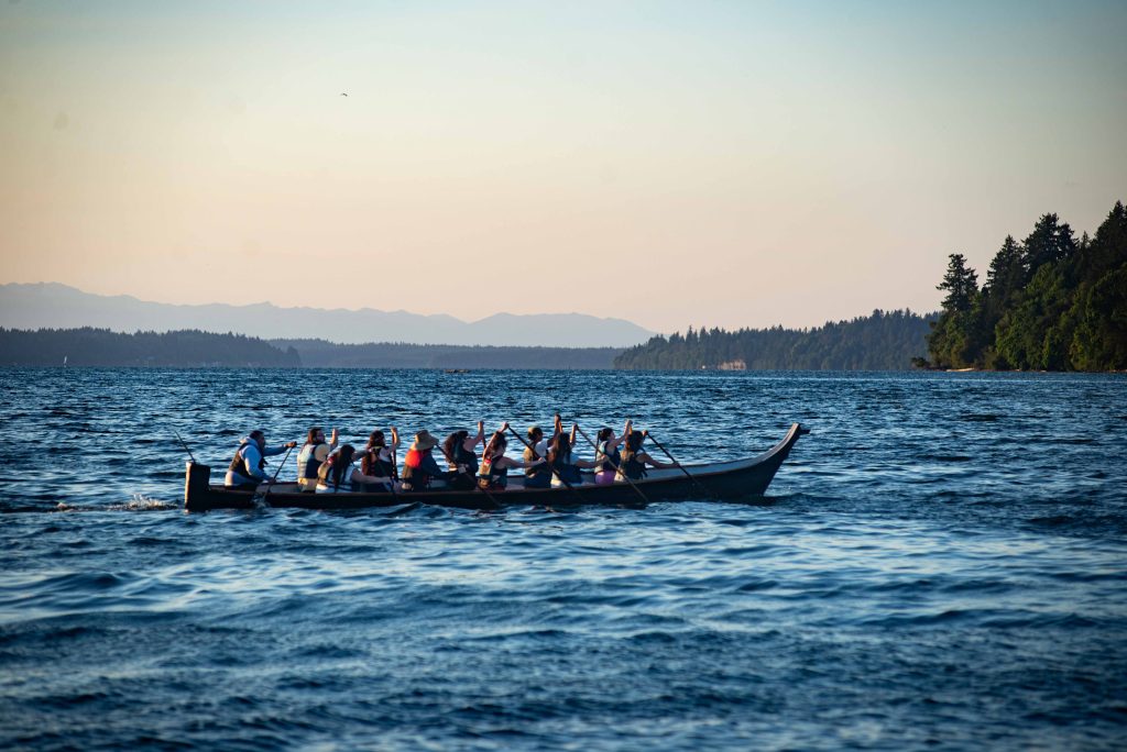 Squaxin Island Tribal members in canoes on the puget sound