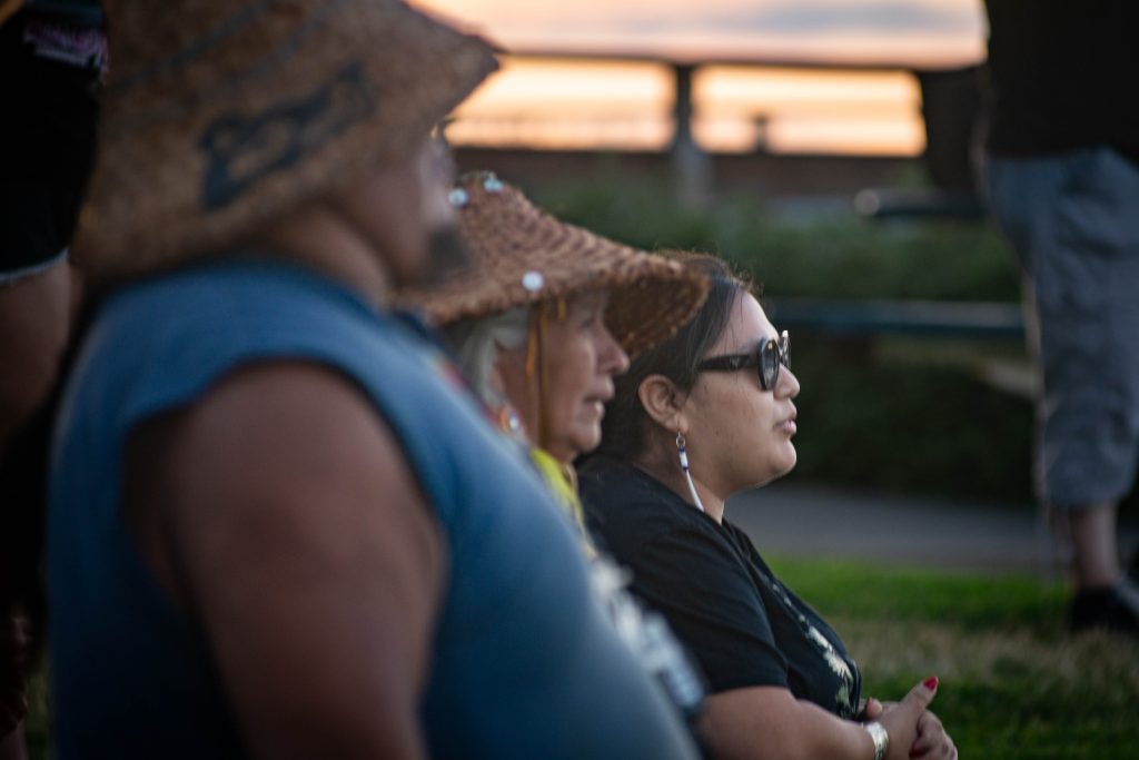 members of the Squaxin Island Tribe stand together on the shore