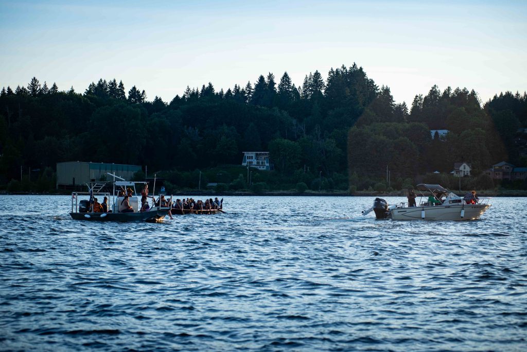 Squaxin Island Tribal members in canoes on the puget sound