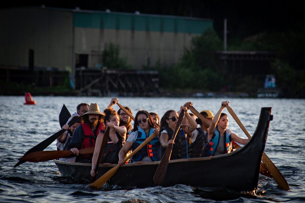 Squaxin Island Tribal members in canoes on the puget sound