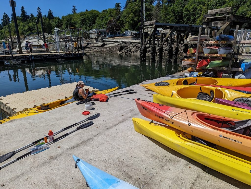 line of kayaks on the dock at Tugboat Annies in Olympia