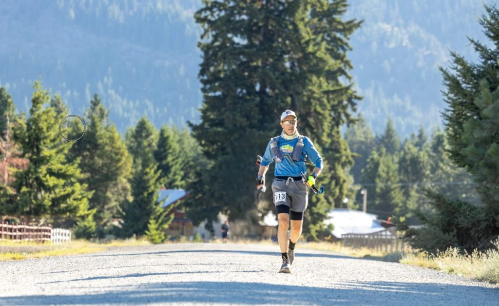Michael Marchand running on a road for the Cascade Crest 100