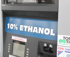 Close up of a gas pump terminal with a blue sticker with white writing that says, '10% Ethanol'
