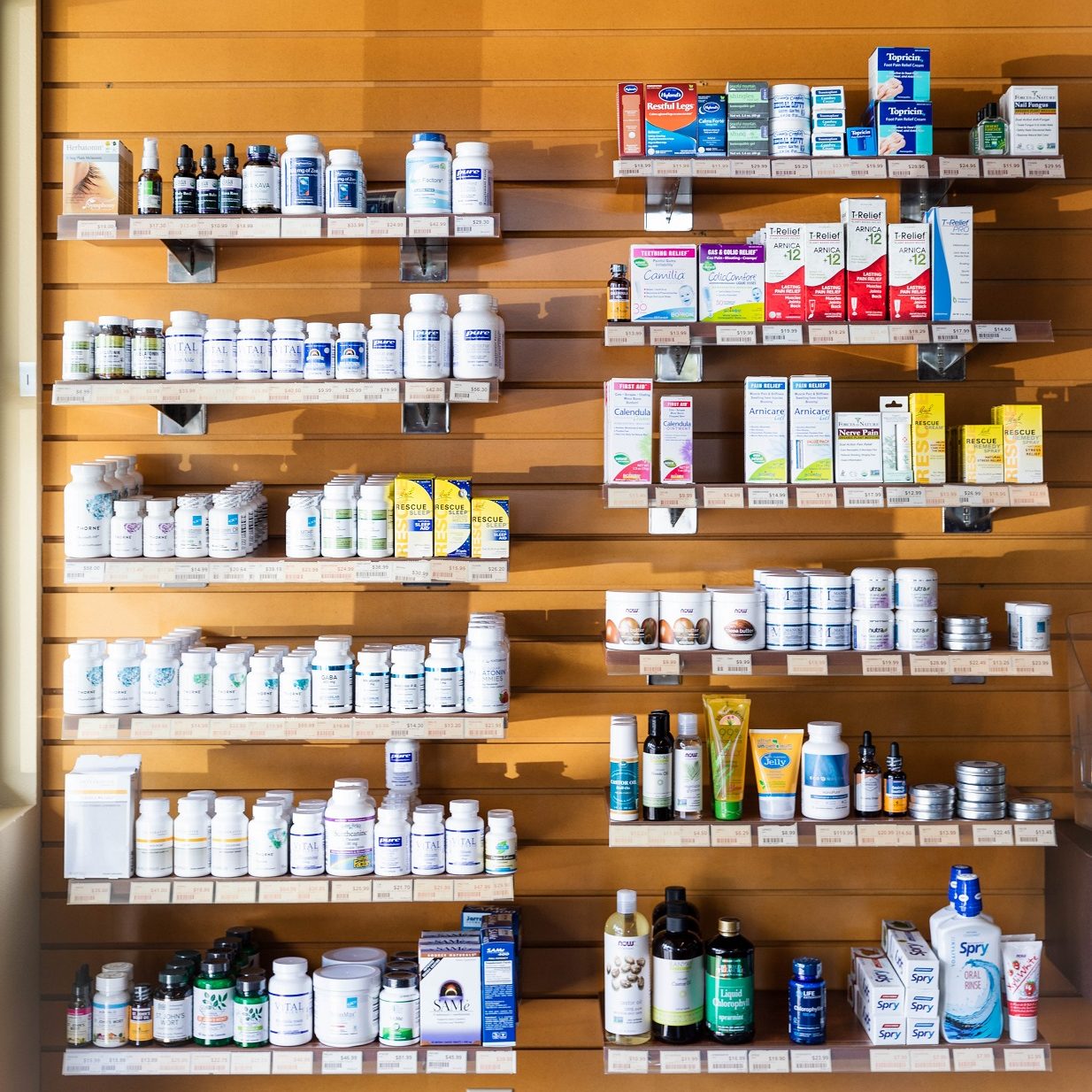 wooden shelves full of pill bottles and boxes