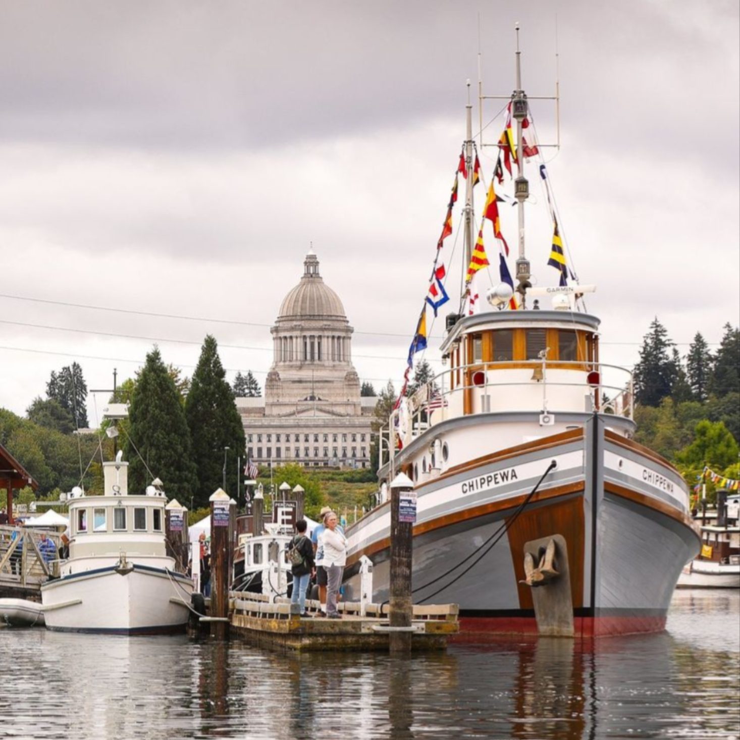 Tug Chippewa on the water with the Olympia capital in the background