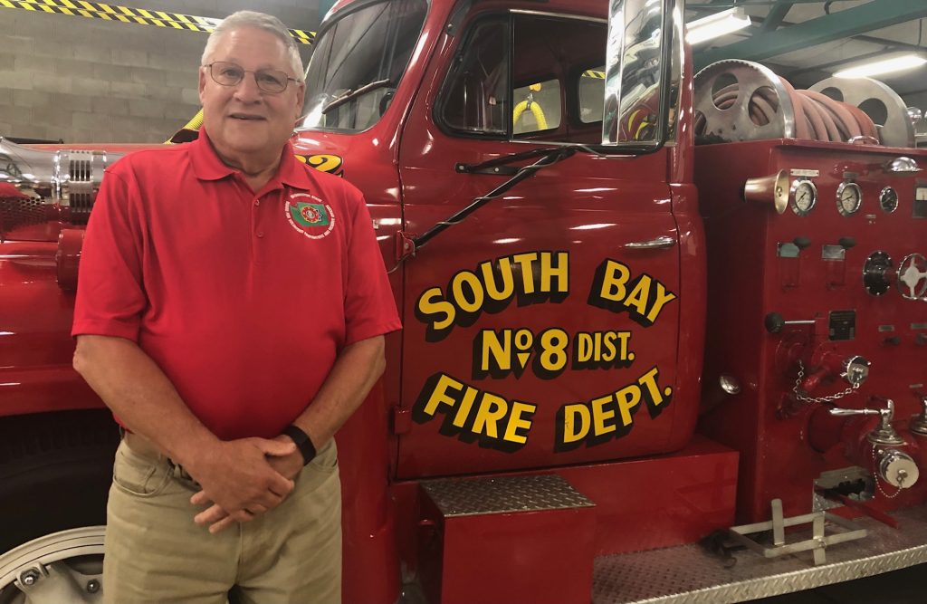 Brian VanCamp standing by a South Bay Fire Dept Fire truck.