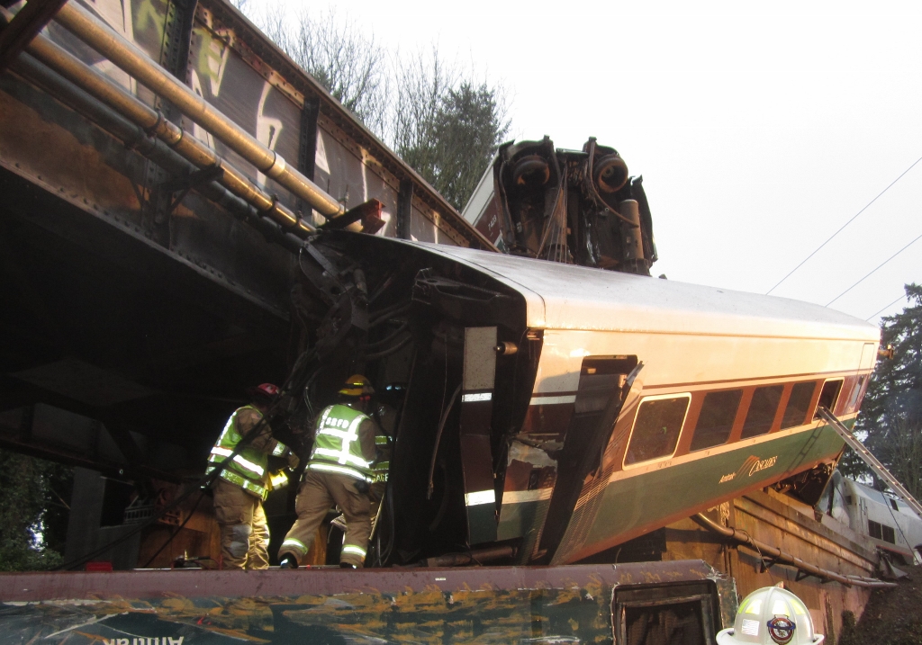 fireman inside a train that has derailed over a freeway