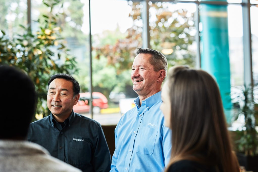 CEO Gary Swindler talking a group of his employees inside a WSECU branch