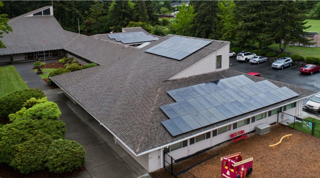 aerial view of a large building with solar panels on the roof