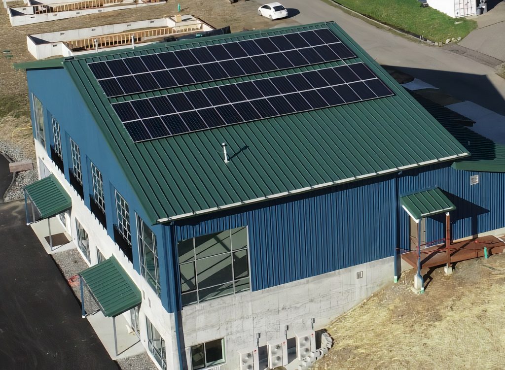 aerial view of a large building with solar panels on the roof