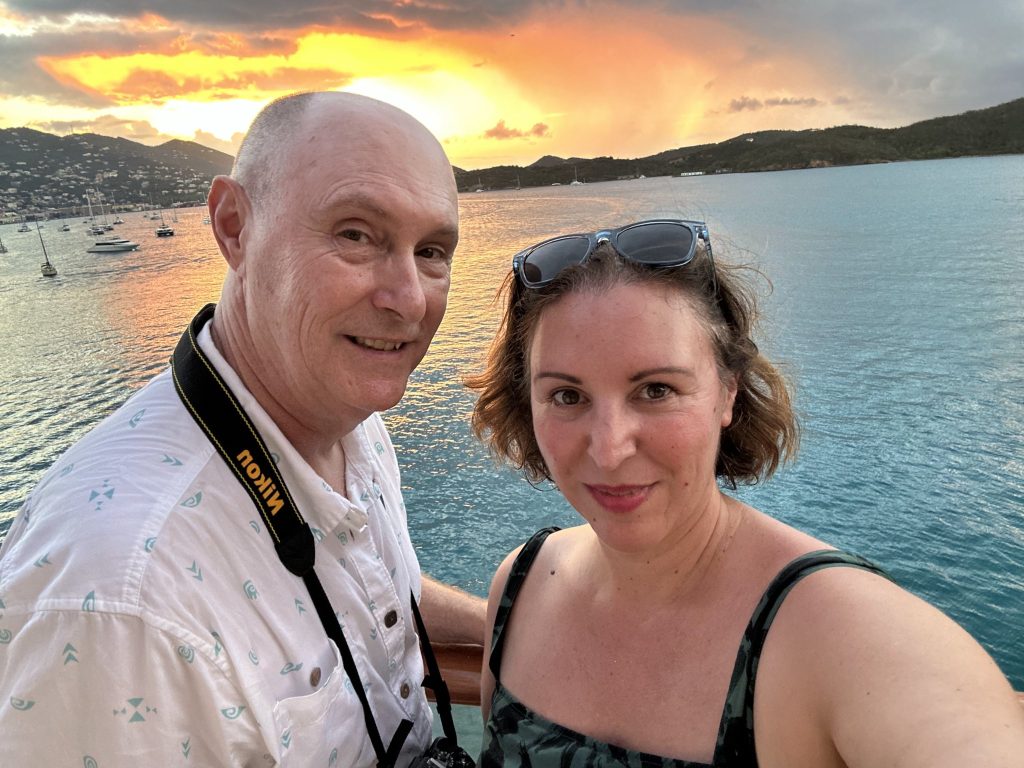 Sheryl and Larry Beck take a selfie on a boat at sunset
