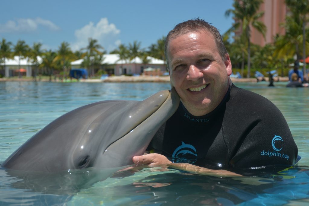 Dr. Iuliano in the water with a dolphin