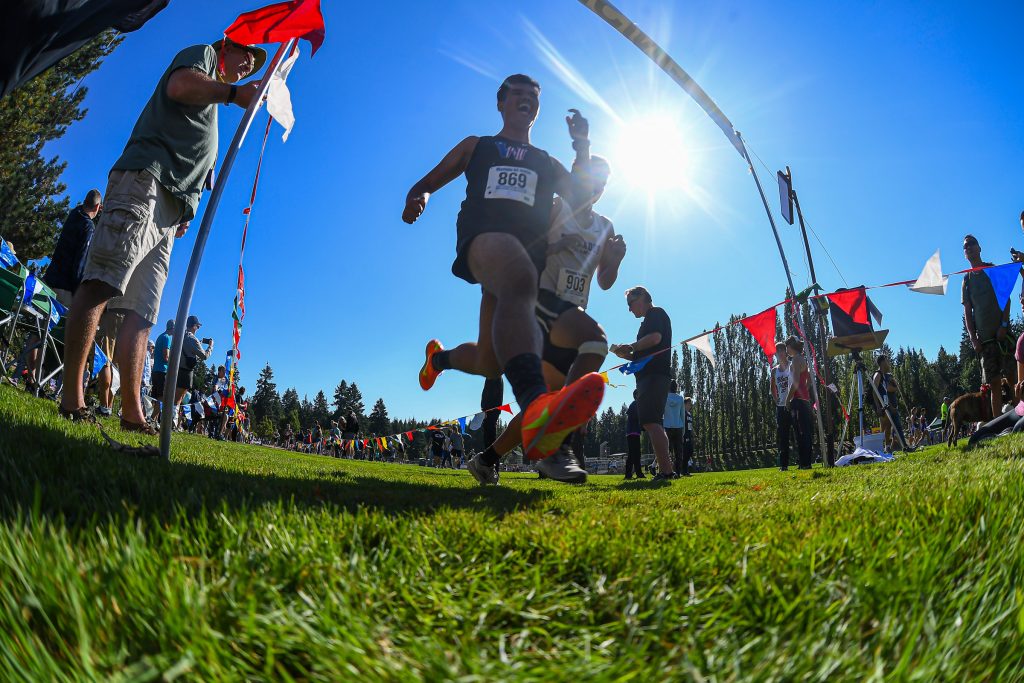 high school athletes running cross country at a meet