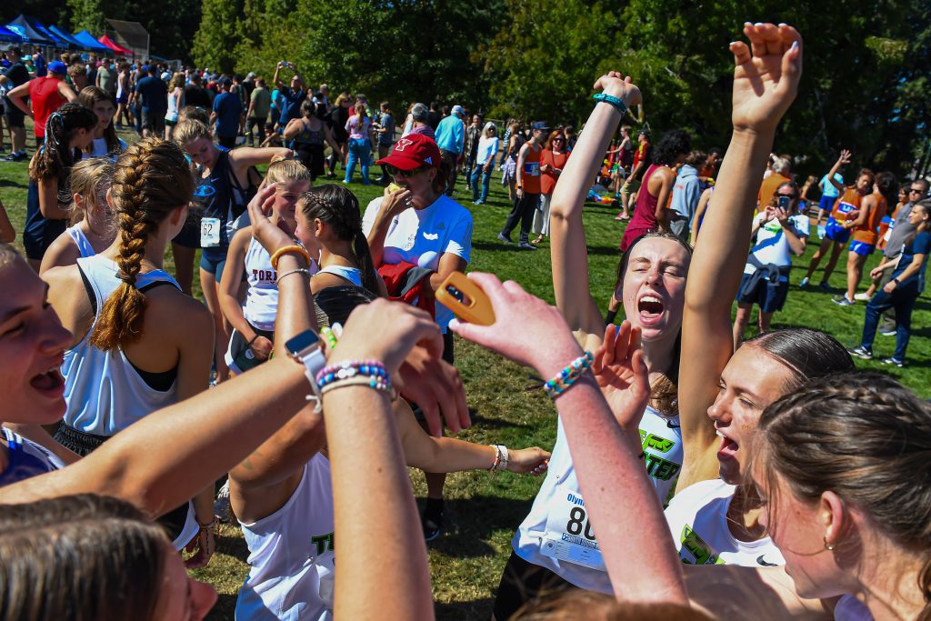 high school athletes running cross country at a meet