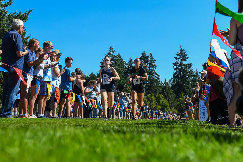high school athletes running cross country at a meet