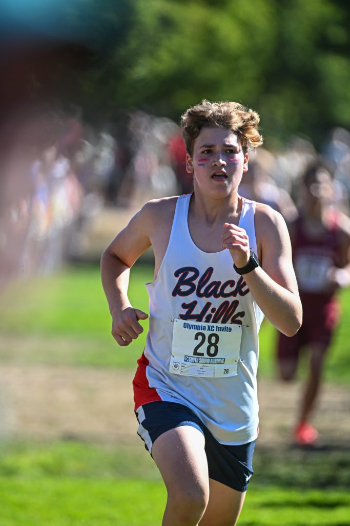 high school athletes running cross country at a meet