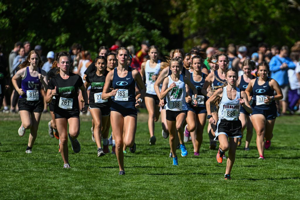 high school athletes running cross country at a meet