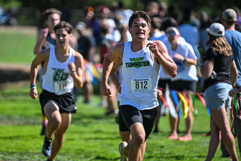 high school athletes running cross country at a meet