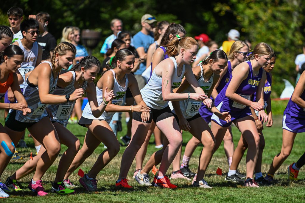 high school athletes running cross country at a meet