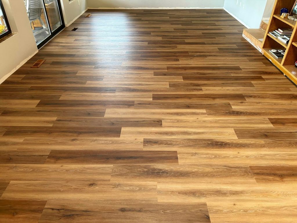 photo of an empty room with a textured vinyl plank floor that looks like wood