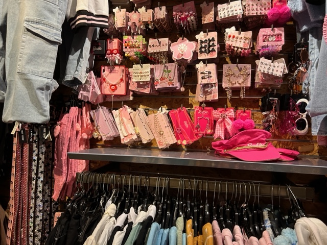Hot Topic store display with a bunch of pink Barbie accessories