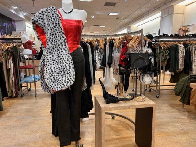 Windsor display with a red corset and black skirt on a mannequin with a black and white spotted faux fur wrap on  its shoulder.