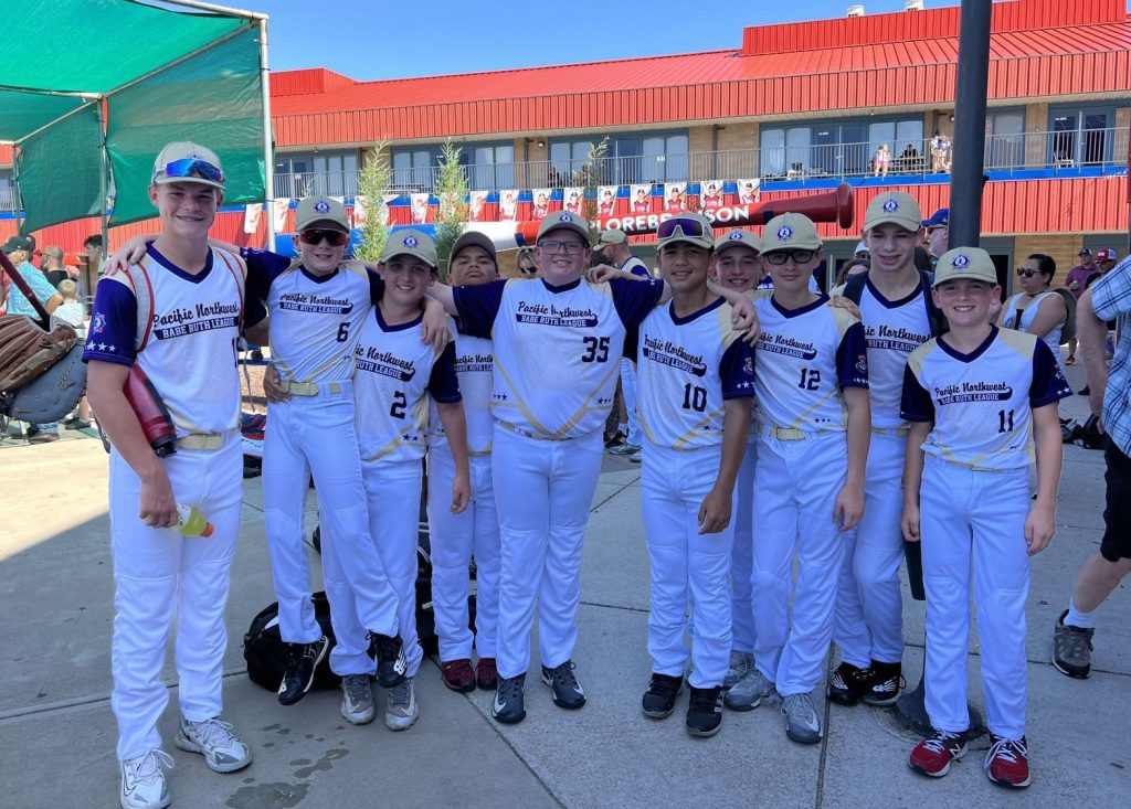 Black HIlls Youth Baseball team photo with stadium behind them