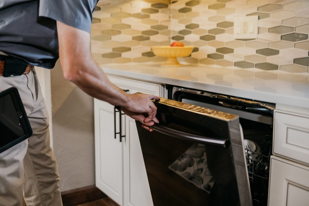 Boggs Inspection Services technician opening up an oven