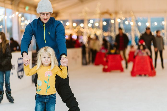 kids and adults ice skating in Olympia in a rink under a tent