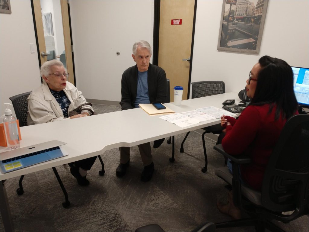 Michelle Jimenea sitting at a table with two other people