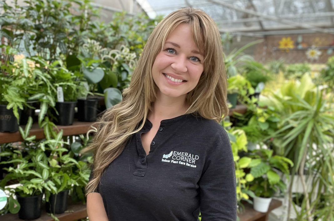 Marie Gaze headshot with a bunch of plants behind her