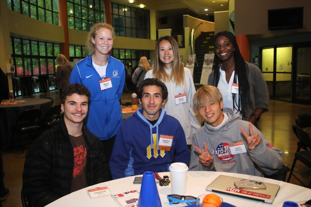 Six SPSCC student athletes gather around the table at the Sports Award.