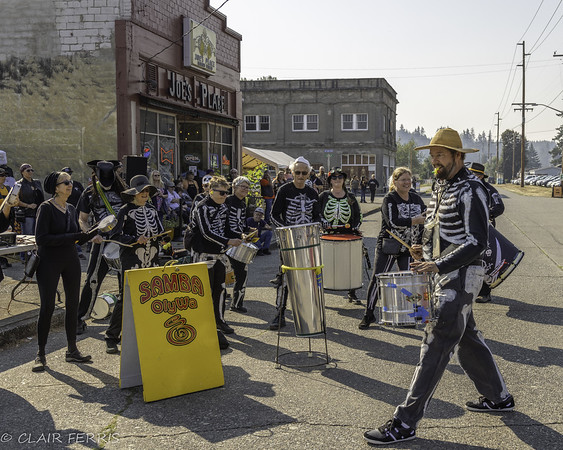 a band dressed as skeletons plays in the street in Bucoda, Wash. as part of BOO-CODA