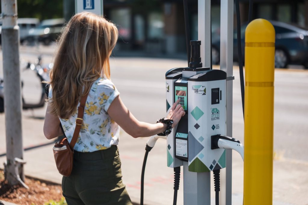 a person using an EV charger at the Olympia Yacht Club