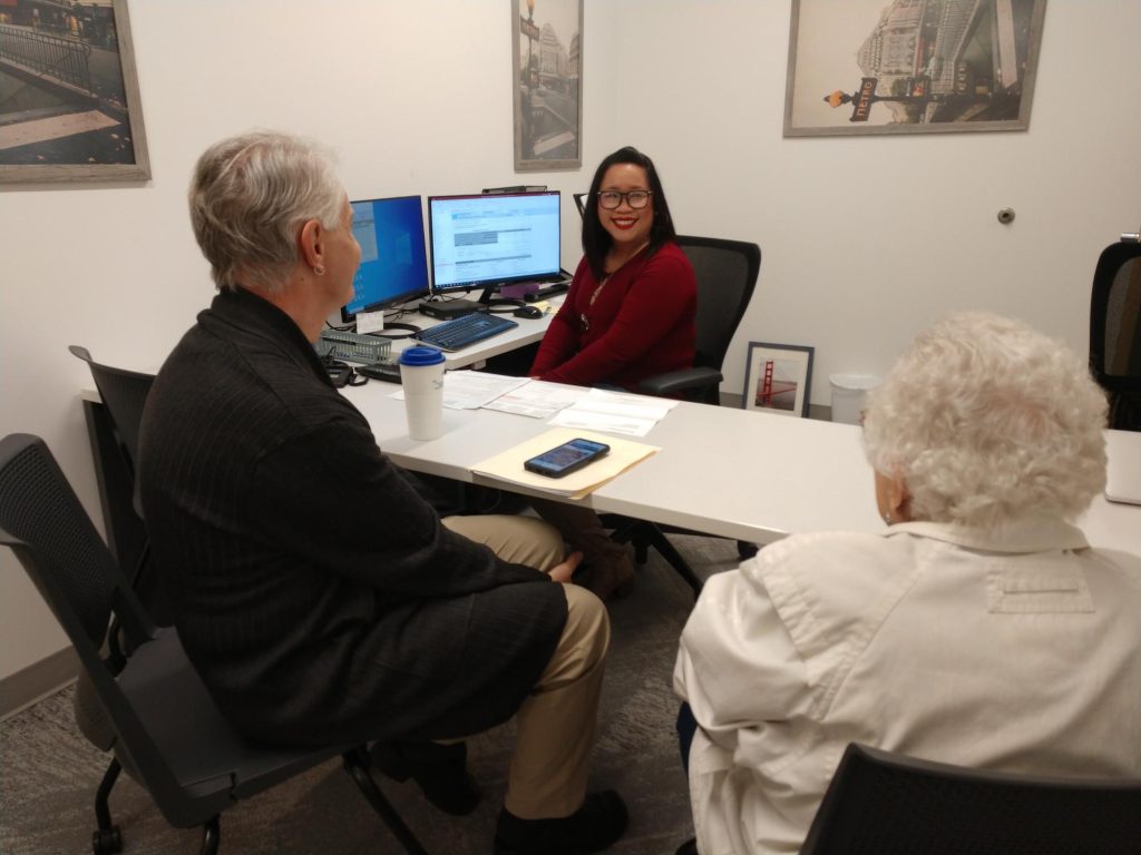 Michelle Jimenea sitting at a table with two other people 