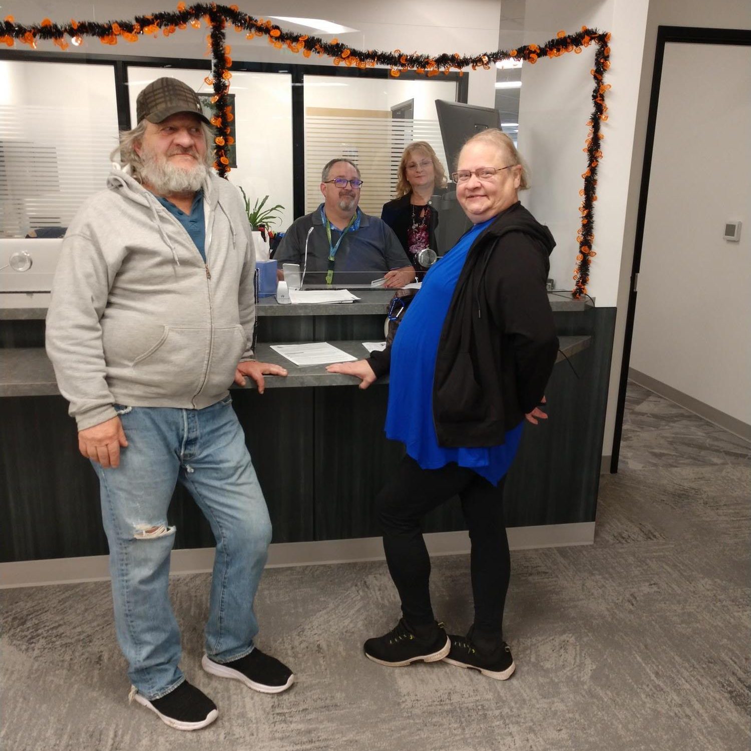 Garry and Teri Baker in front of the Thurston County Assessor's Office window