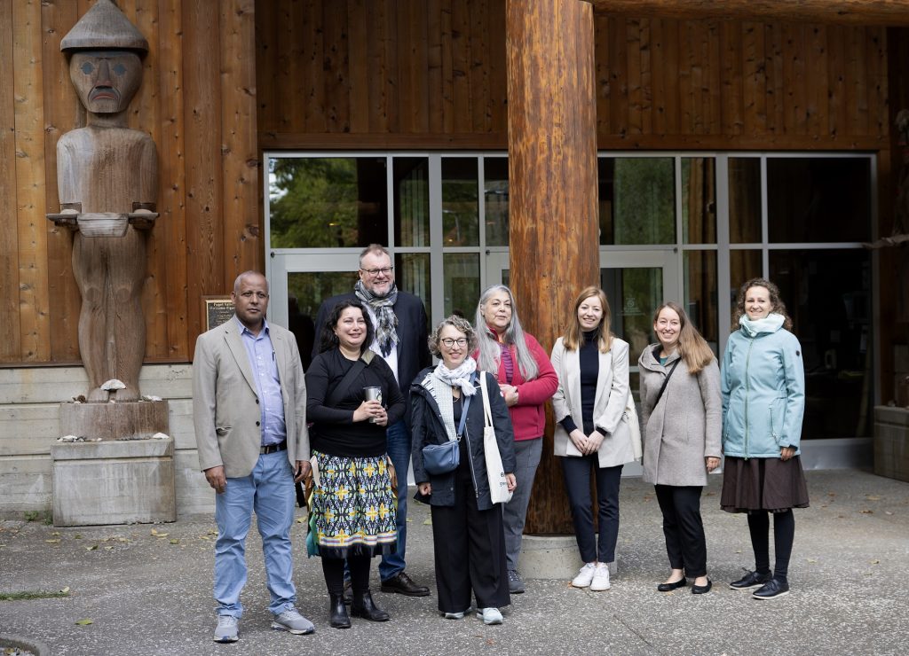 outside of the Squaxin Island Museum with people standing outside posing for a photo