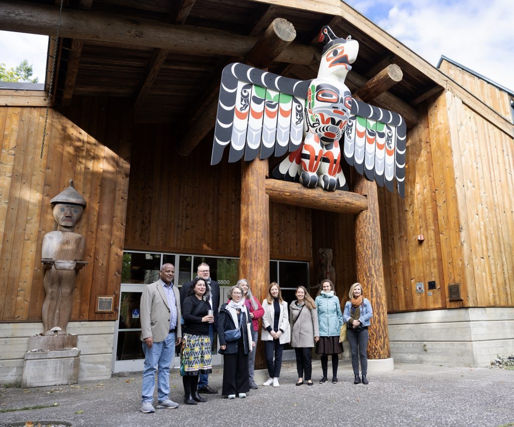 outside of the Squaxin Island Museum with people standing outside posing for a photo