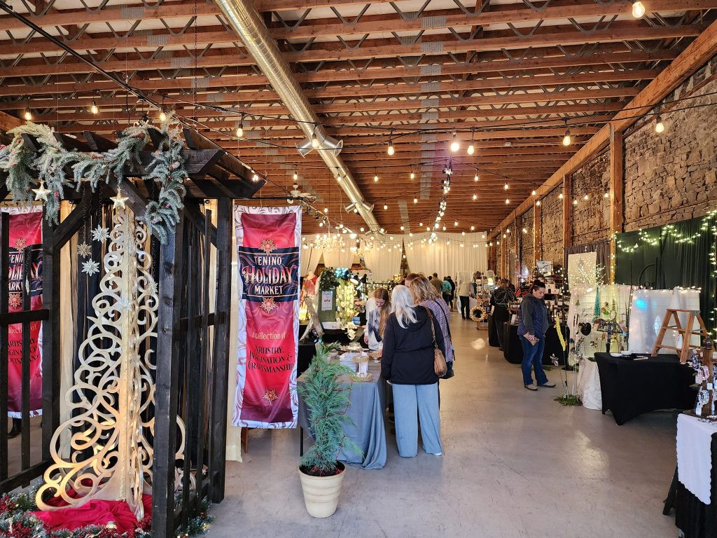 rows of vendors inside a large building at the Tenino Holiday Market