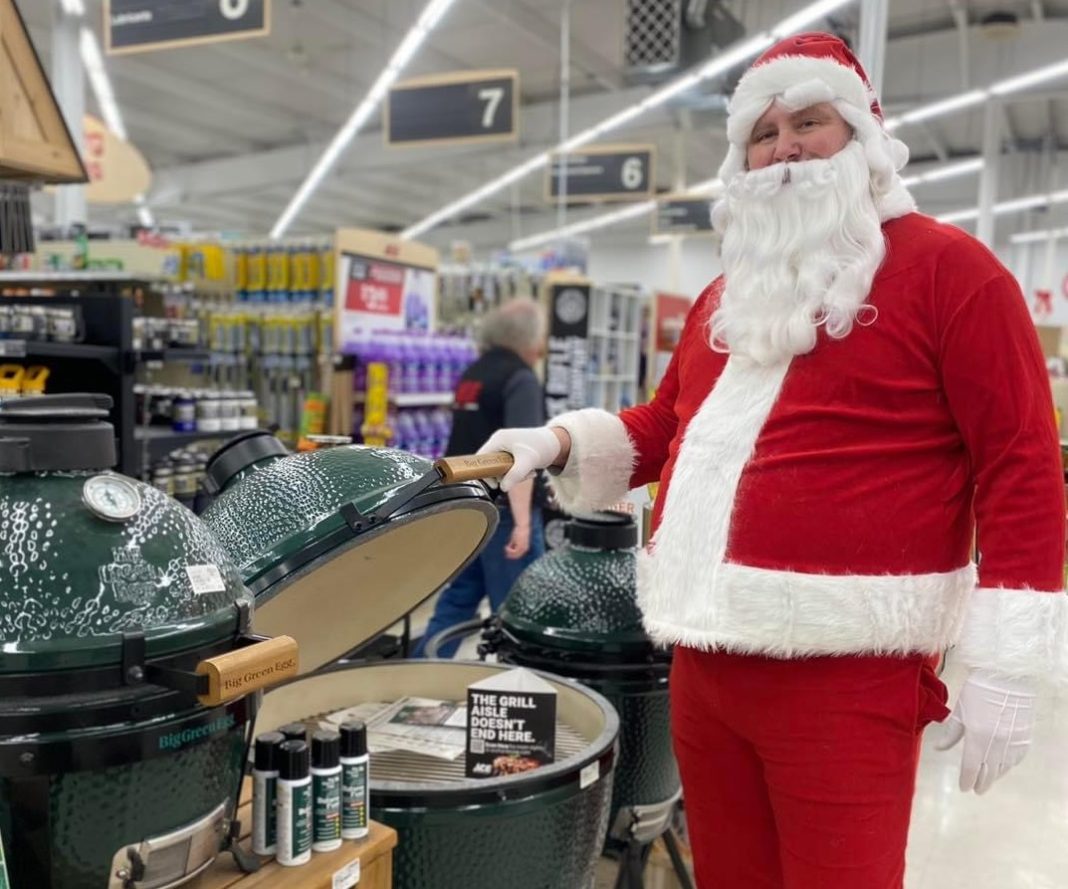 Santa opening the lid on a Green Egg Grill in Lincoln Creek Lumber