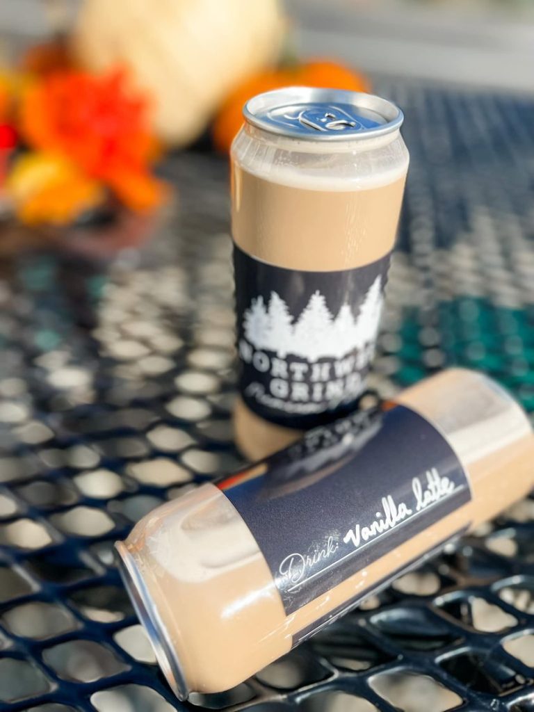 two brown cans, one laying on its side, on a wire table