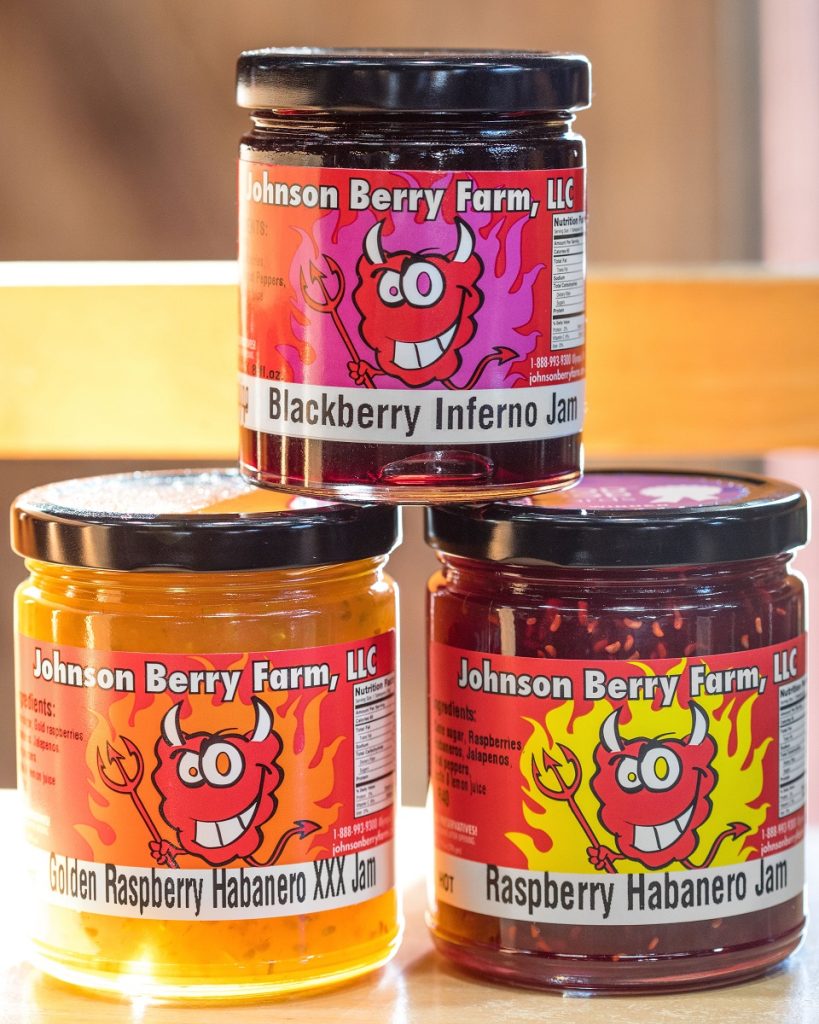 three spicy jams made by Johnson Berry Farm stacked together