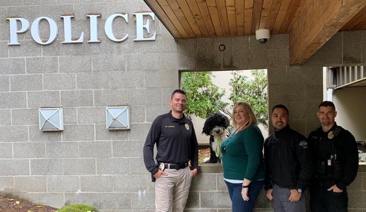 three people standing outside the Lacey Police building