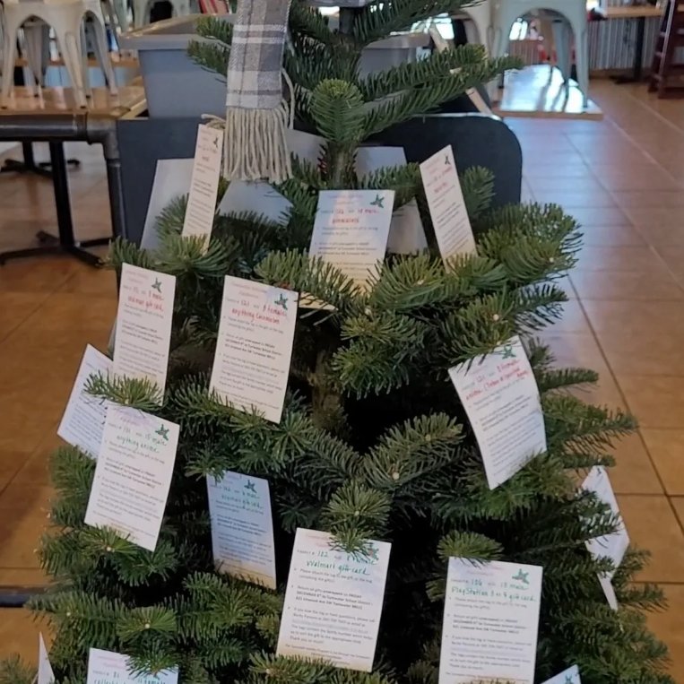 Christmas tree with white tags all over it