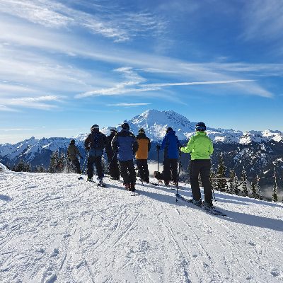 line of skiers on a mountain slope