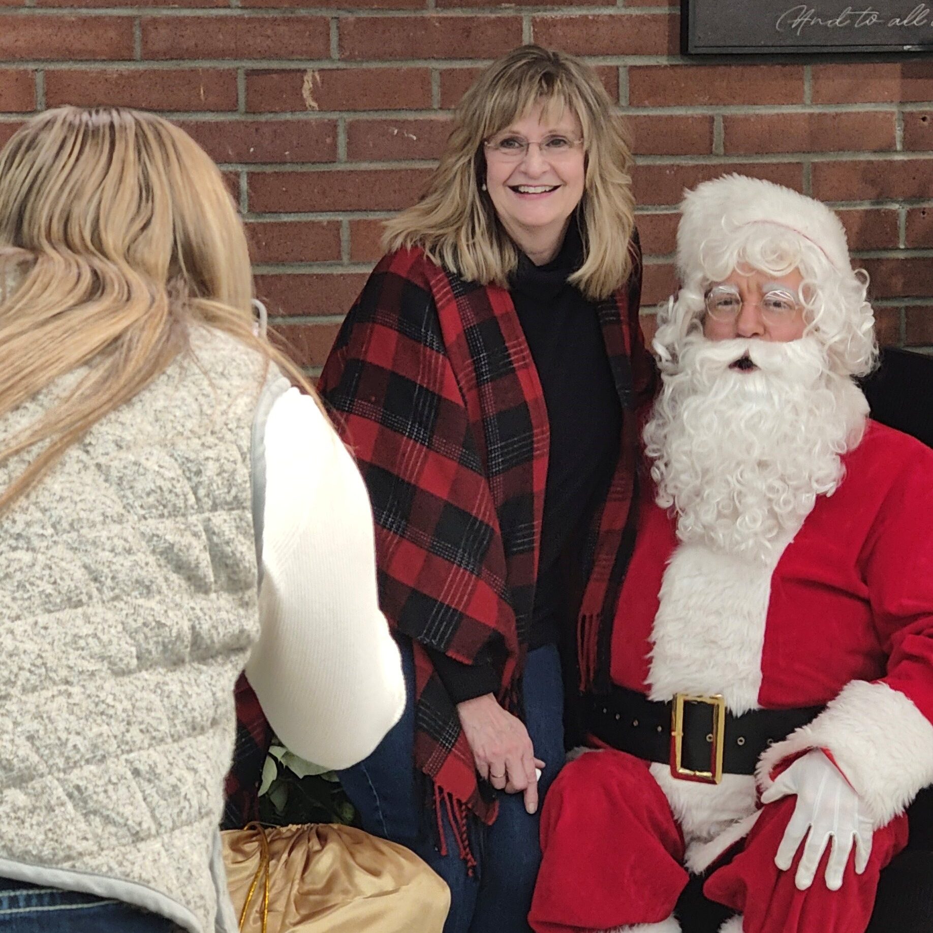 a woman gets her photo with santa