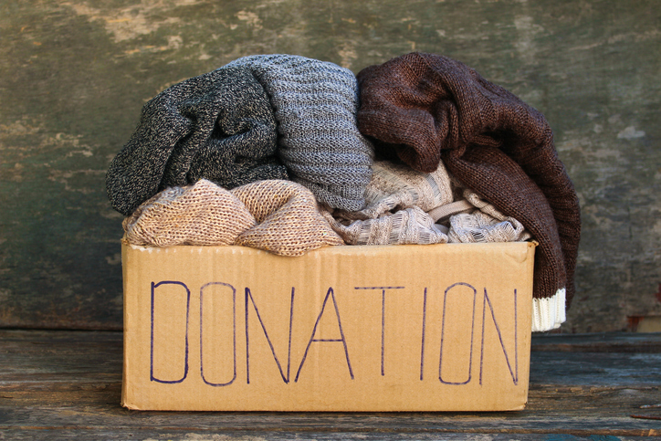 Box of warm winter clothing labeled “Donation”