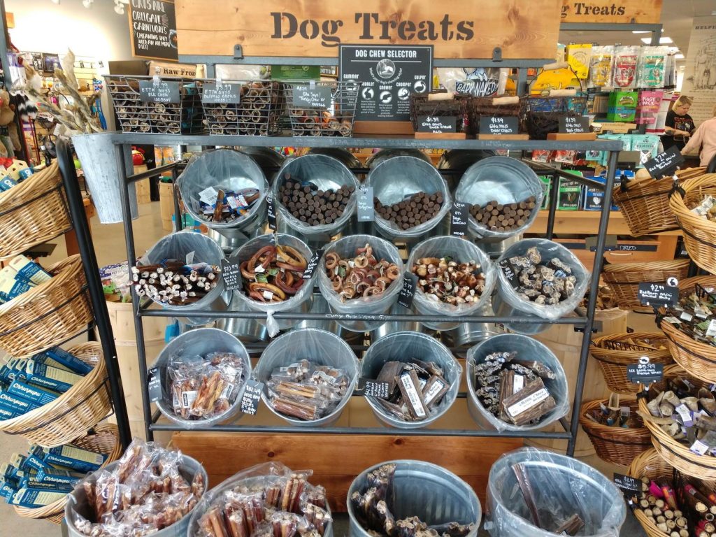 Large rack of dog treat in bins and baskets