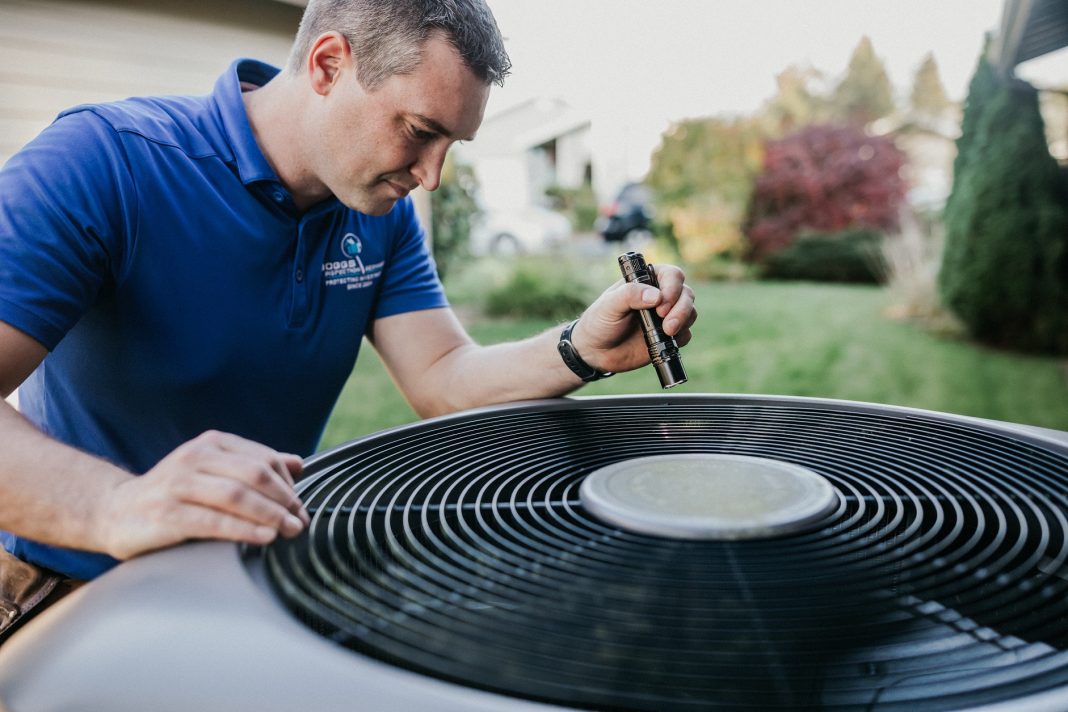 Boggs technician inspecting an air conditioner